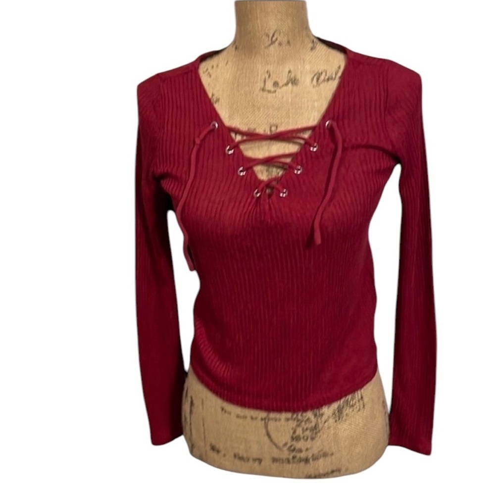 Raspberry colored long sleeve shirt with lace up front.